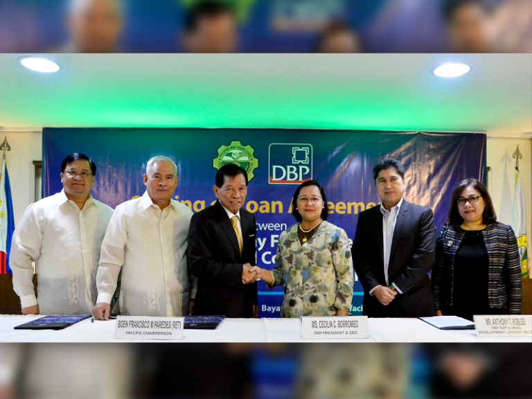 DBP president and chief executive officer Cecilia C. Borromeo shakes hands with PAFCPIC chairman Francisco Paredes after signing a P2-billion loan agreement during ceremonies held last July 26 in Taguig City.